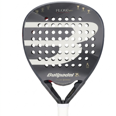 A Bullpadel Flow paddle with a black and white design, featuring a perforated face, gold lettering, and a white wrapped handle, shown against a plain white background.
